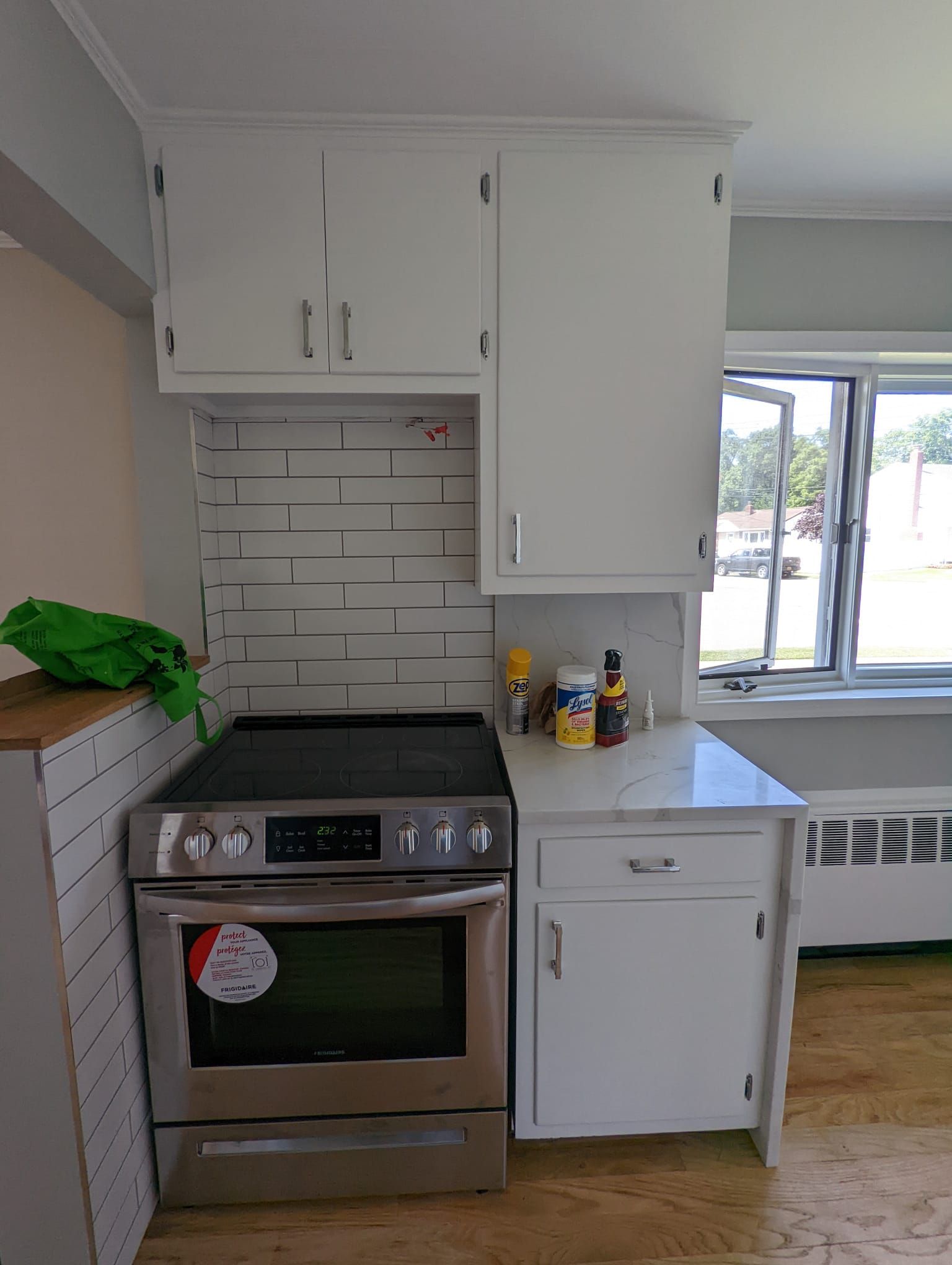 A kitchen with stainless steel appliances and white cabinets.