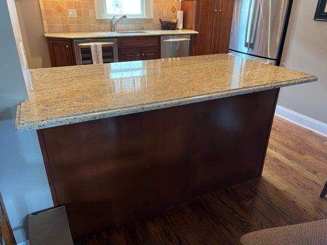 A kitchen with a large island in the middle of it.