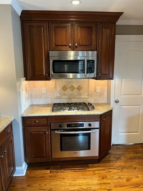 A kitchen with stainless steel appliances and wooden cabinets