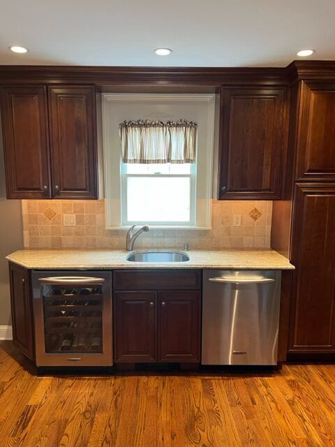 A kitchen with stainless steel appliances and wooden cabinets