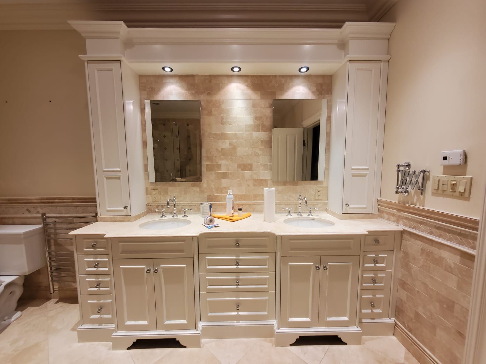 A bathroom with two sinks and a large mirror