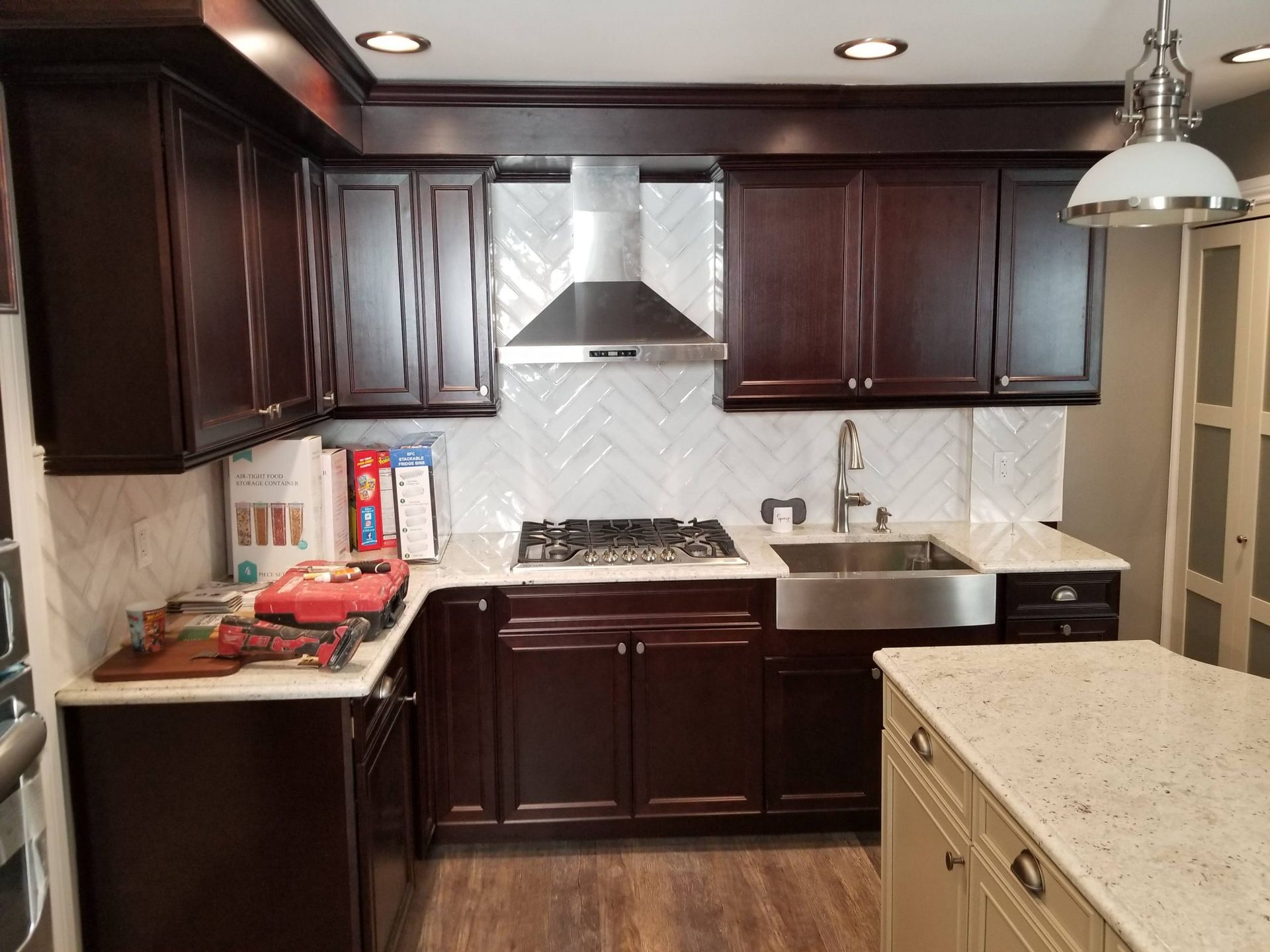 A kitchen with a stove top oven and a sink