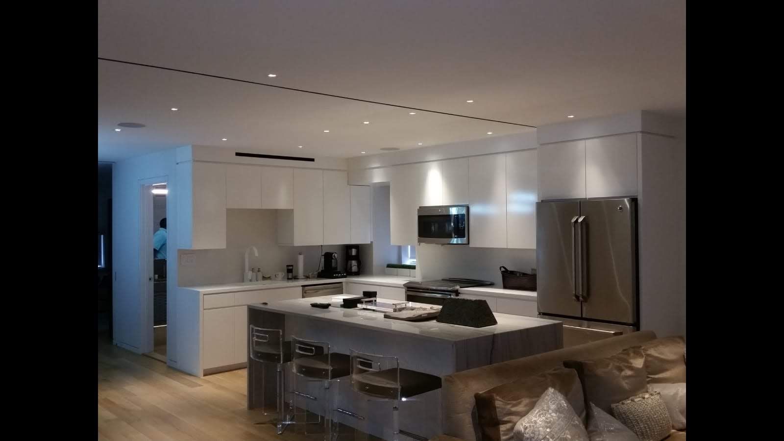 A kitchen with white cabinets and stainless steel appliances