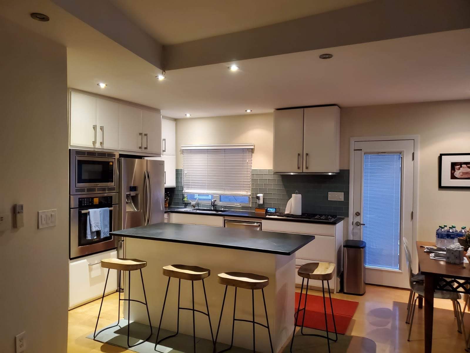 A kitchen with a large island and stools