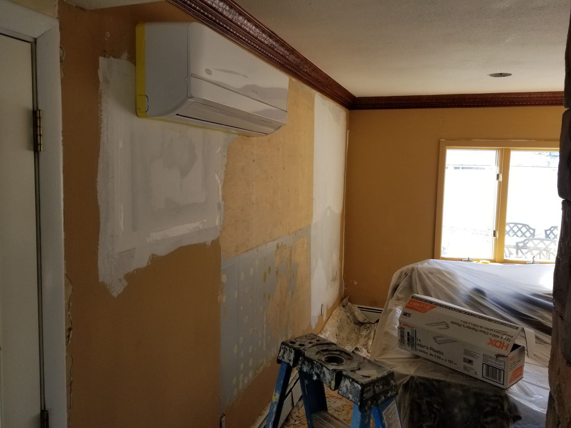 A room with a ladder and a box on it.