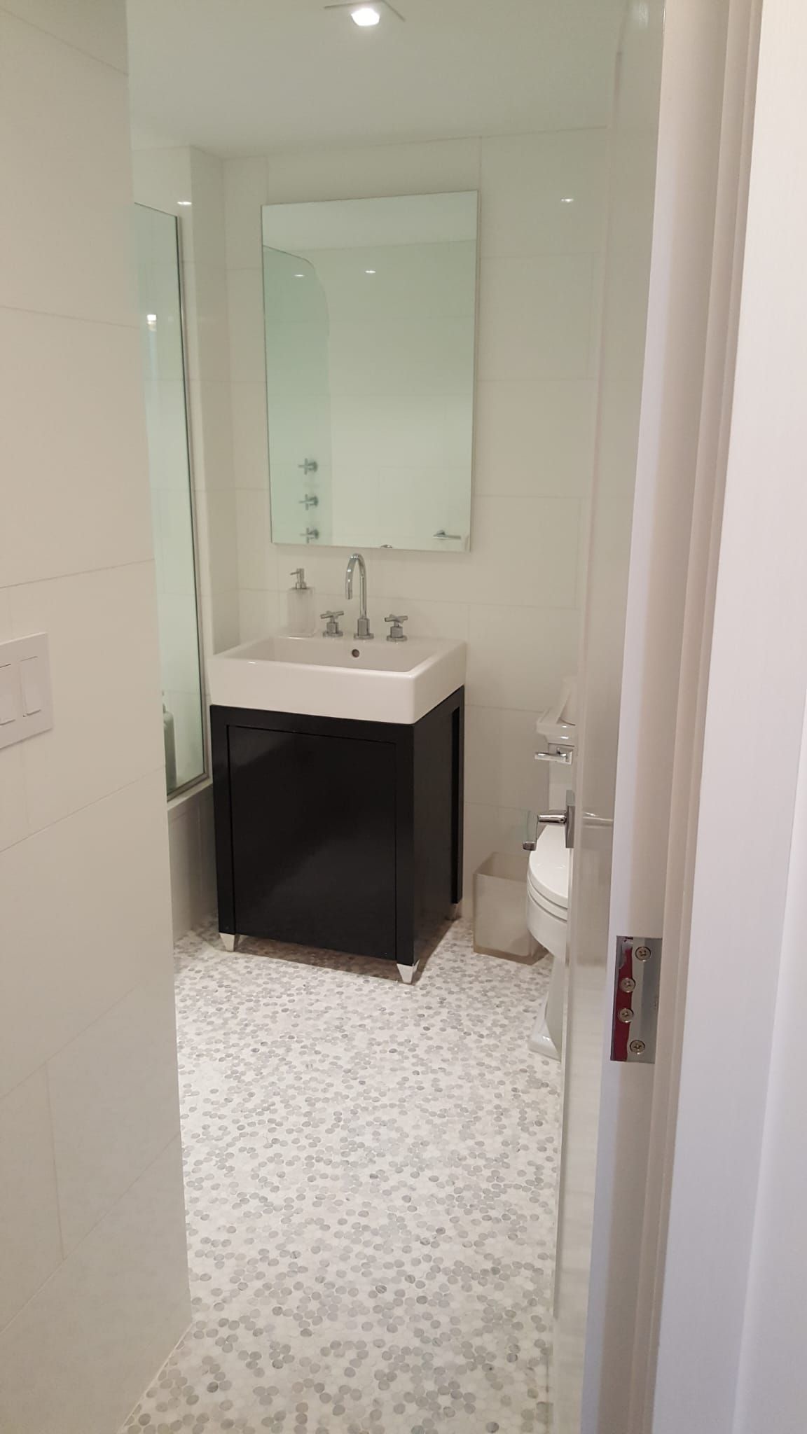 A bathroom with a sink, mirror and toilet.