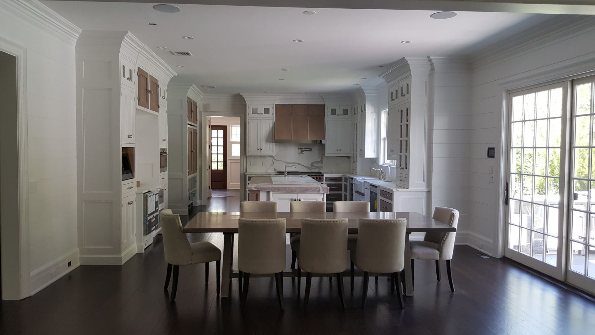 There is a dining table and chairs in the middle of the room.