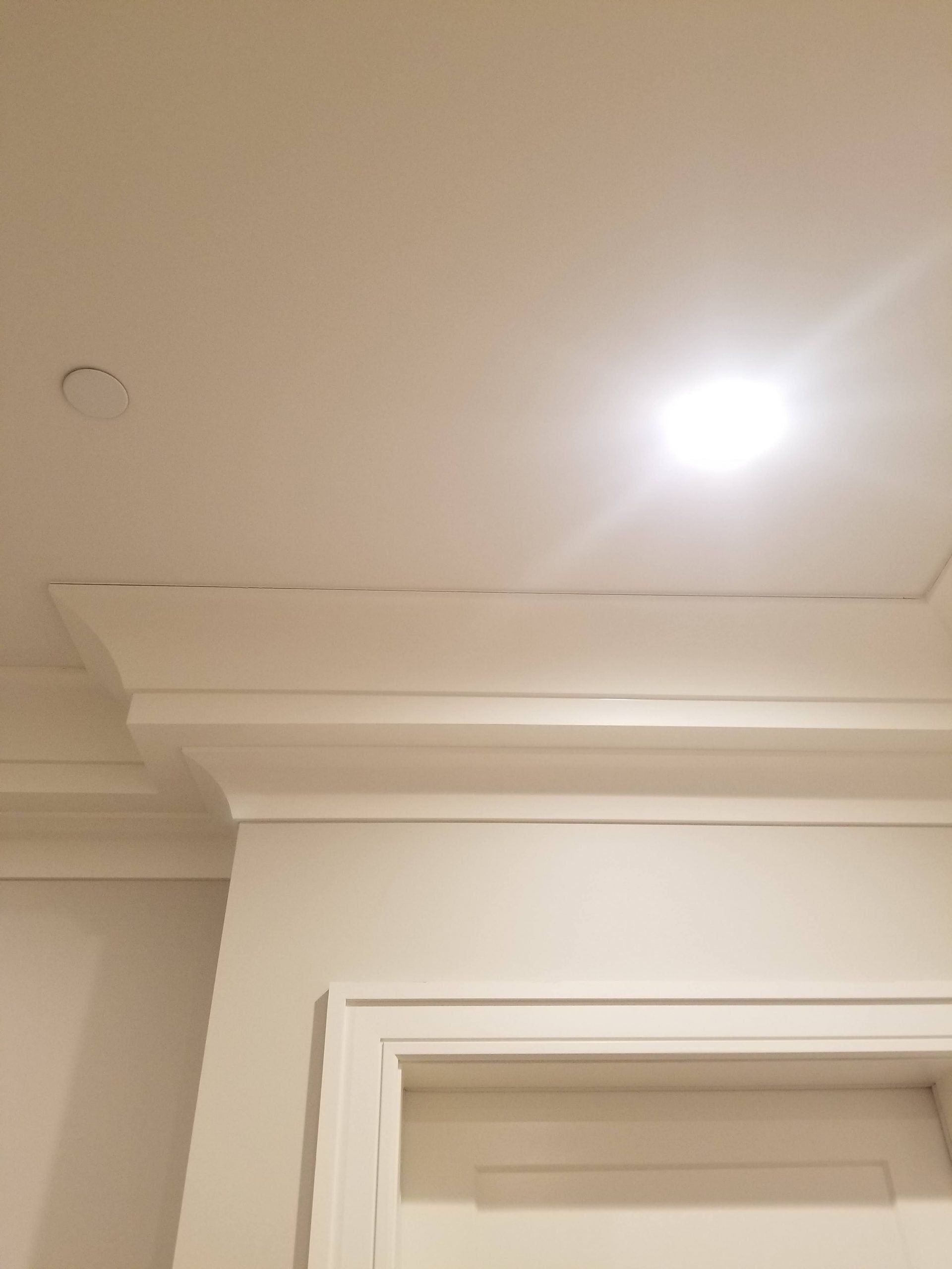 There is a light on the ceiling above the door.