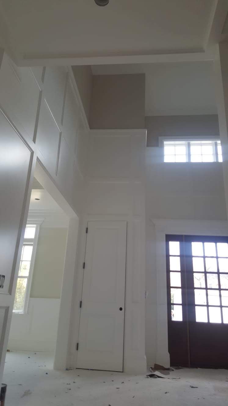 A room with a lot of windows and a ceiling that is very high.