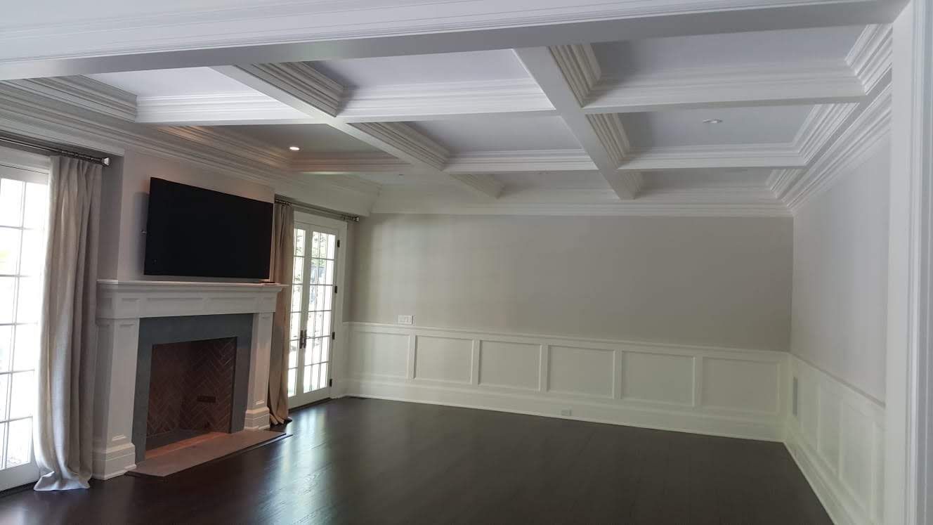 A living room with a fireplace and a flat screen tv.