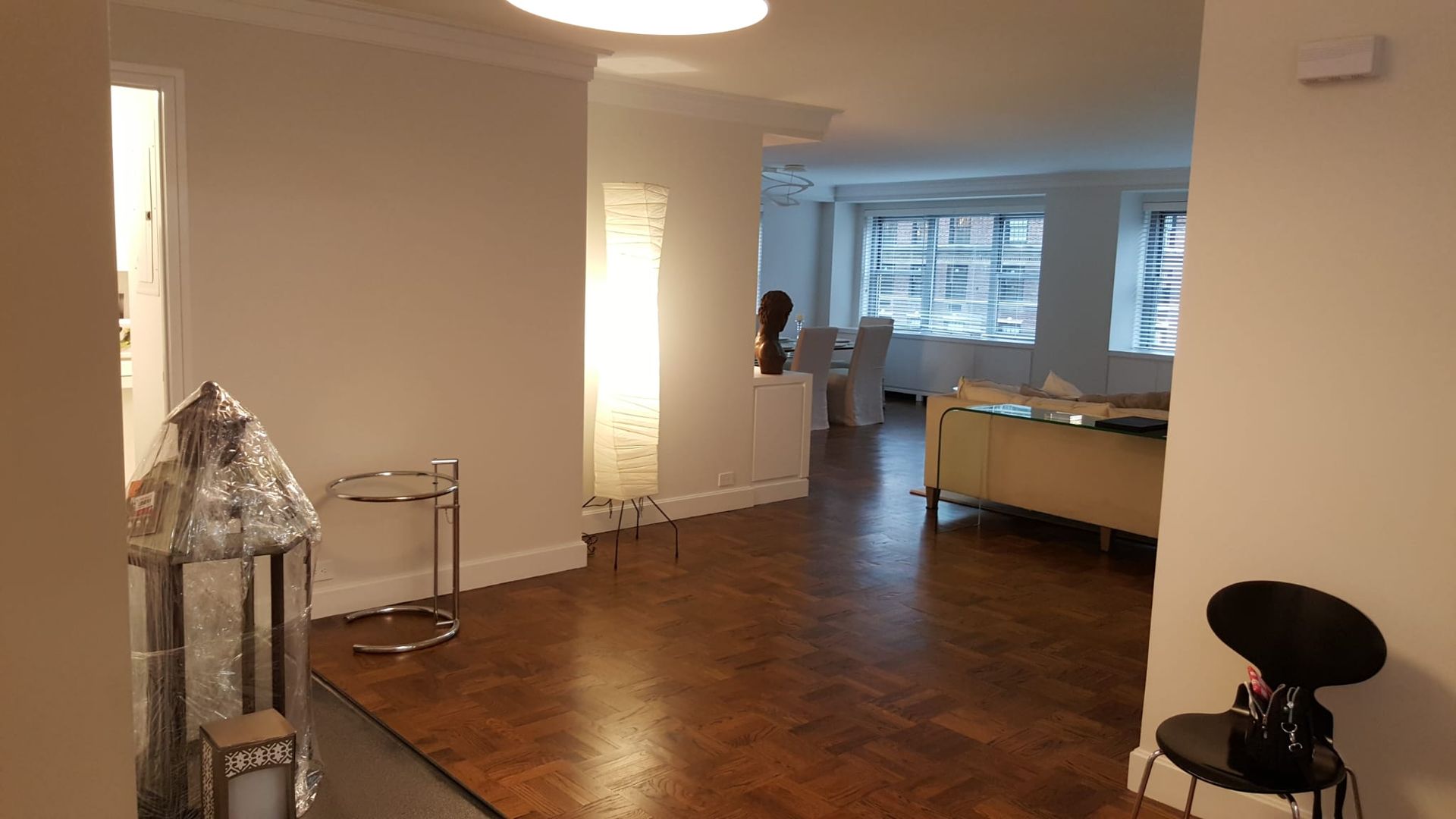A living room with a wooden floor and white walls.