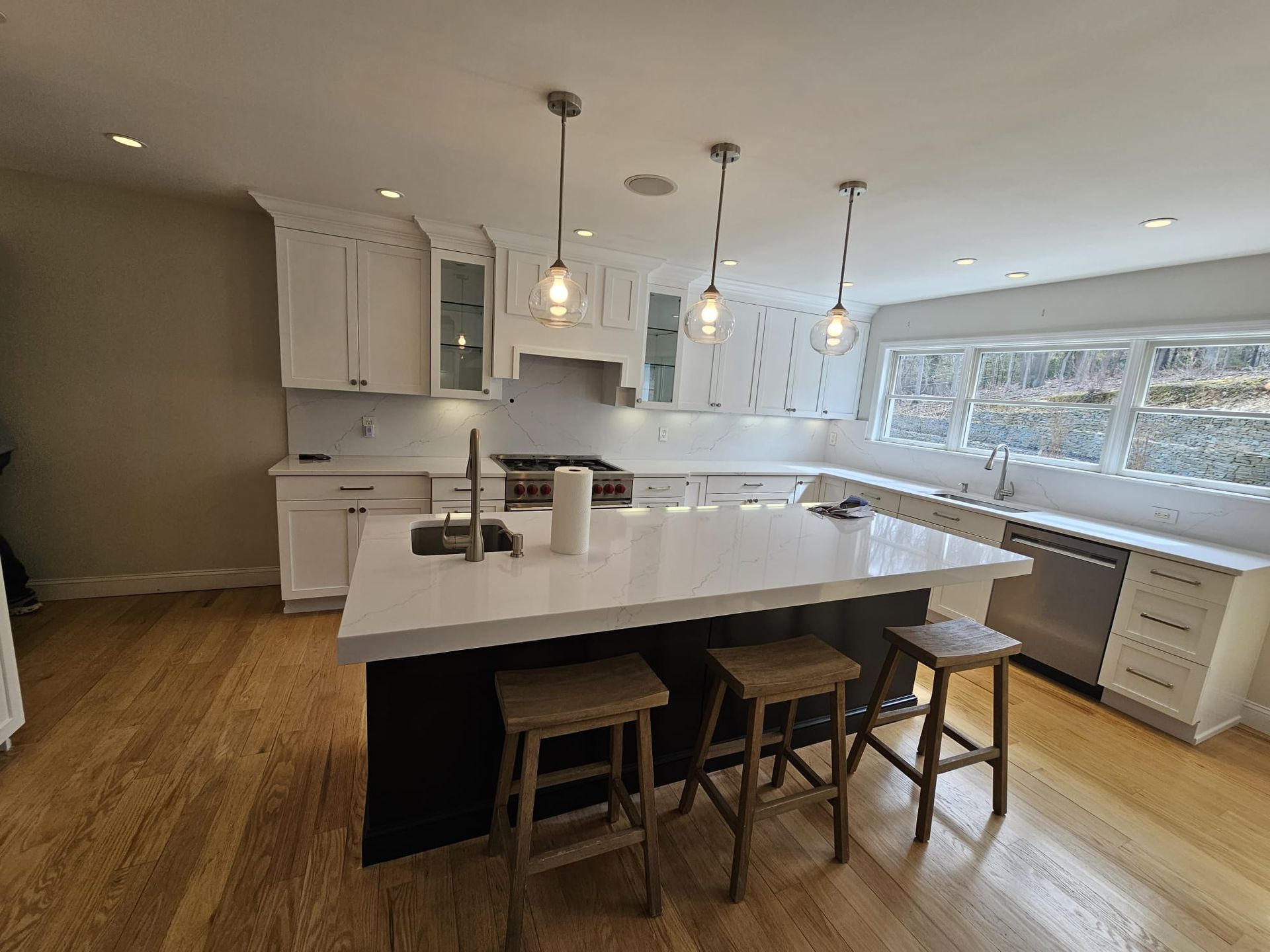 A kitchen with a large island and stools
