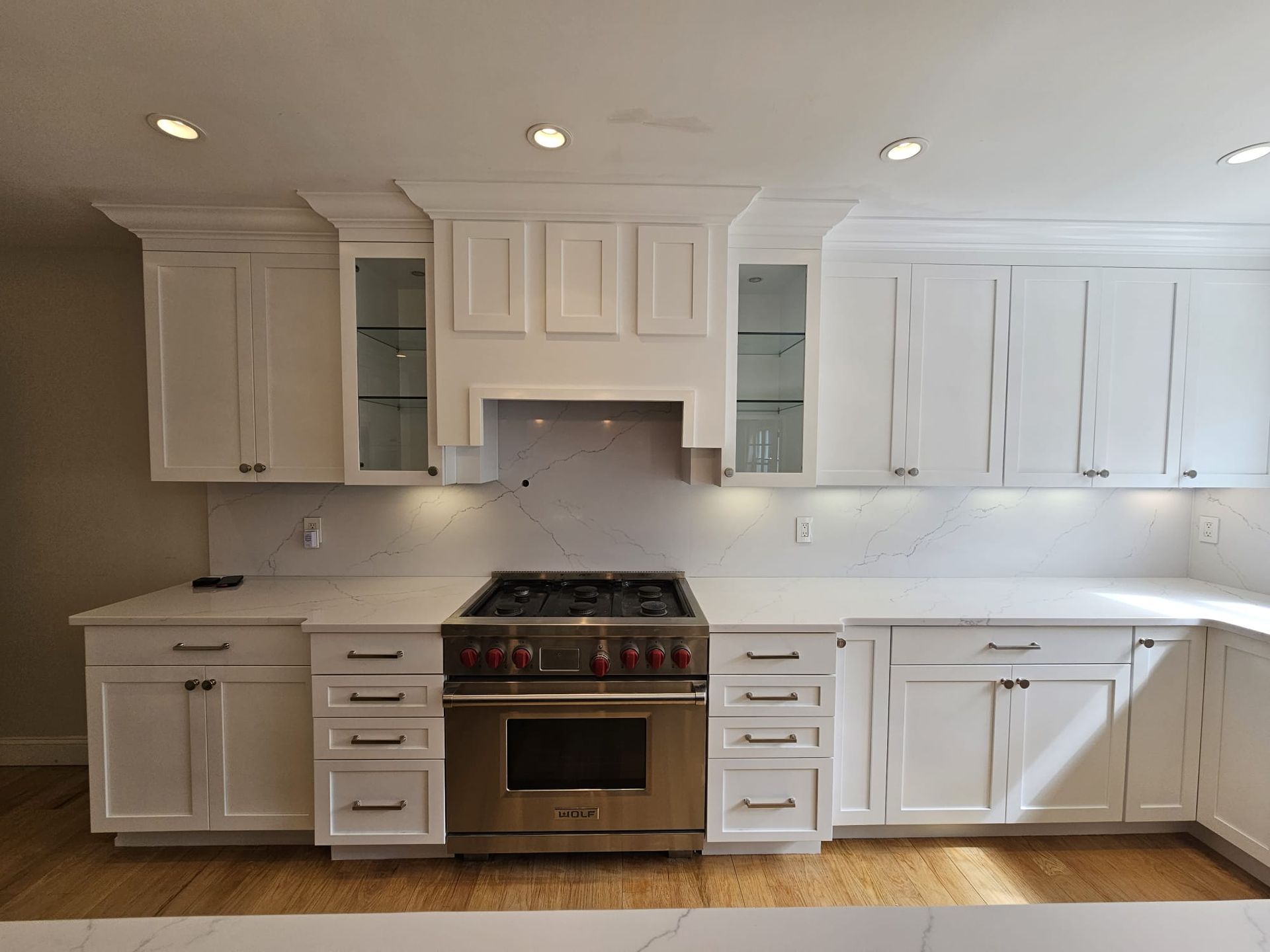 A kitchen with white cabinets and stainless steel appliances