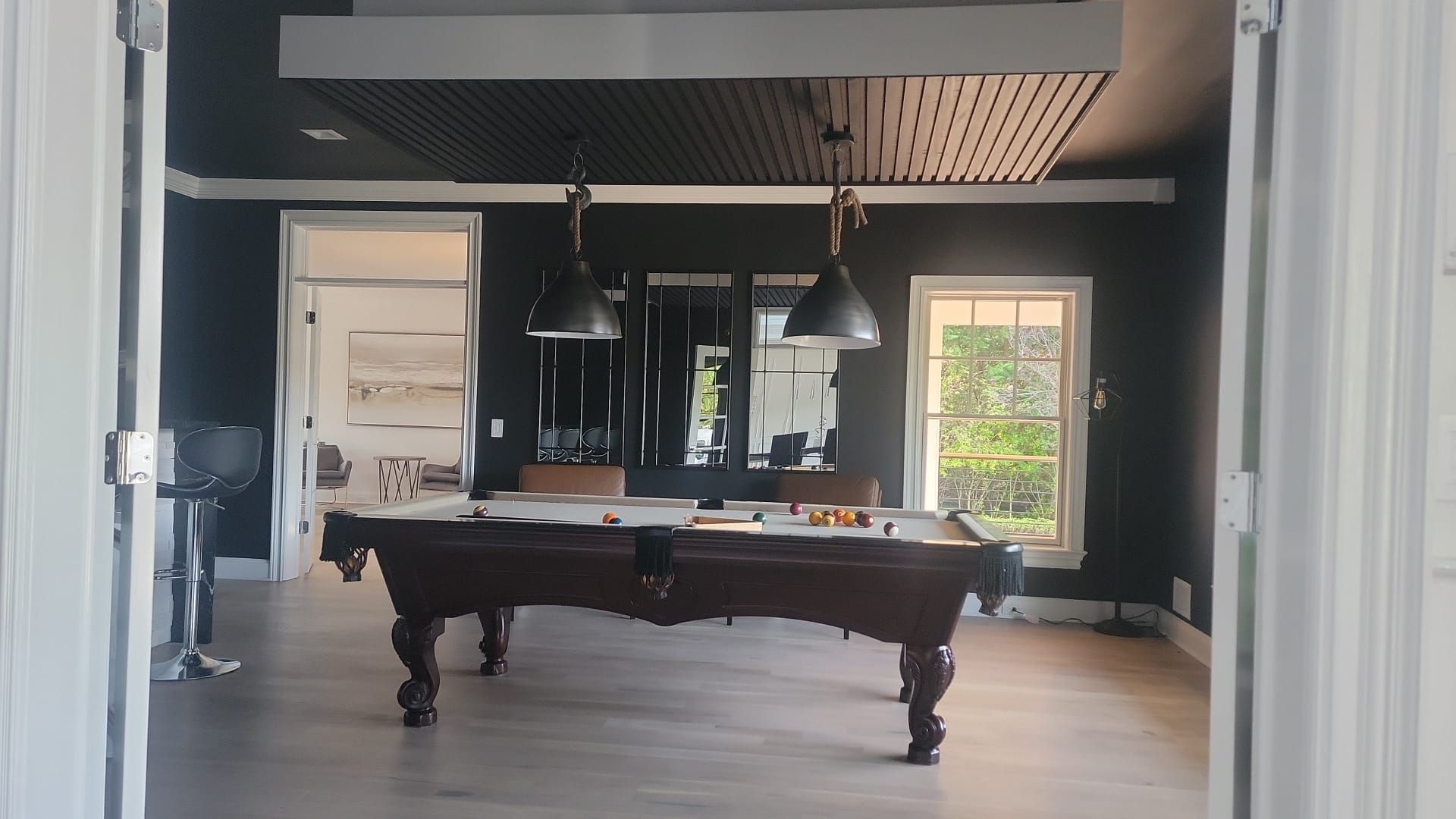 A pool table in a room with black walls
