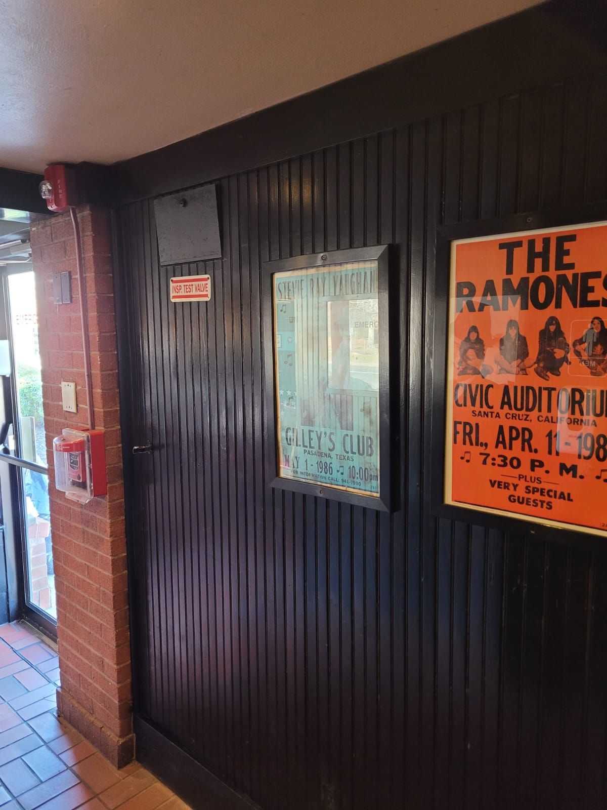 A poster for the ramones hangs on a wall