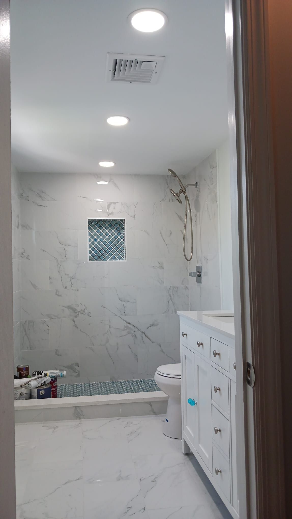 A bathroom with a toilet, sink, and shower.