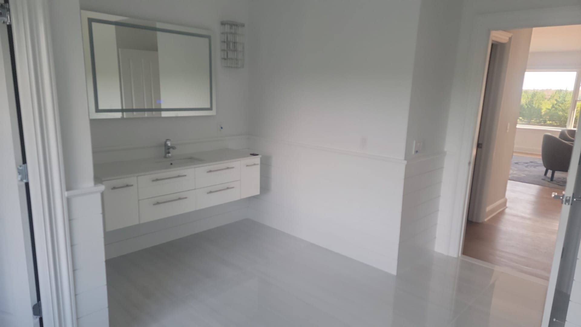 There is a bathroom with a sink and a mirror.