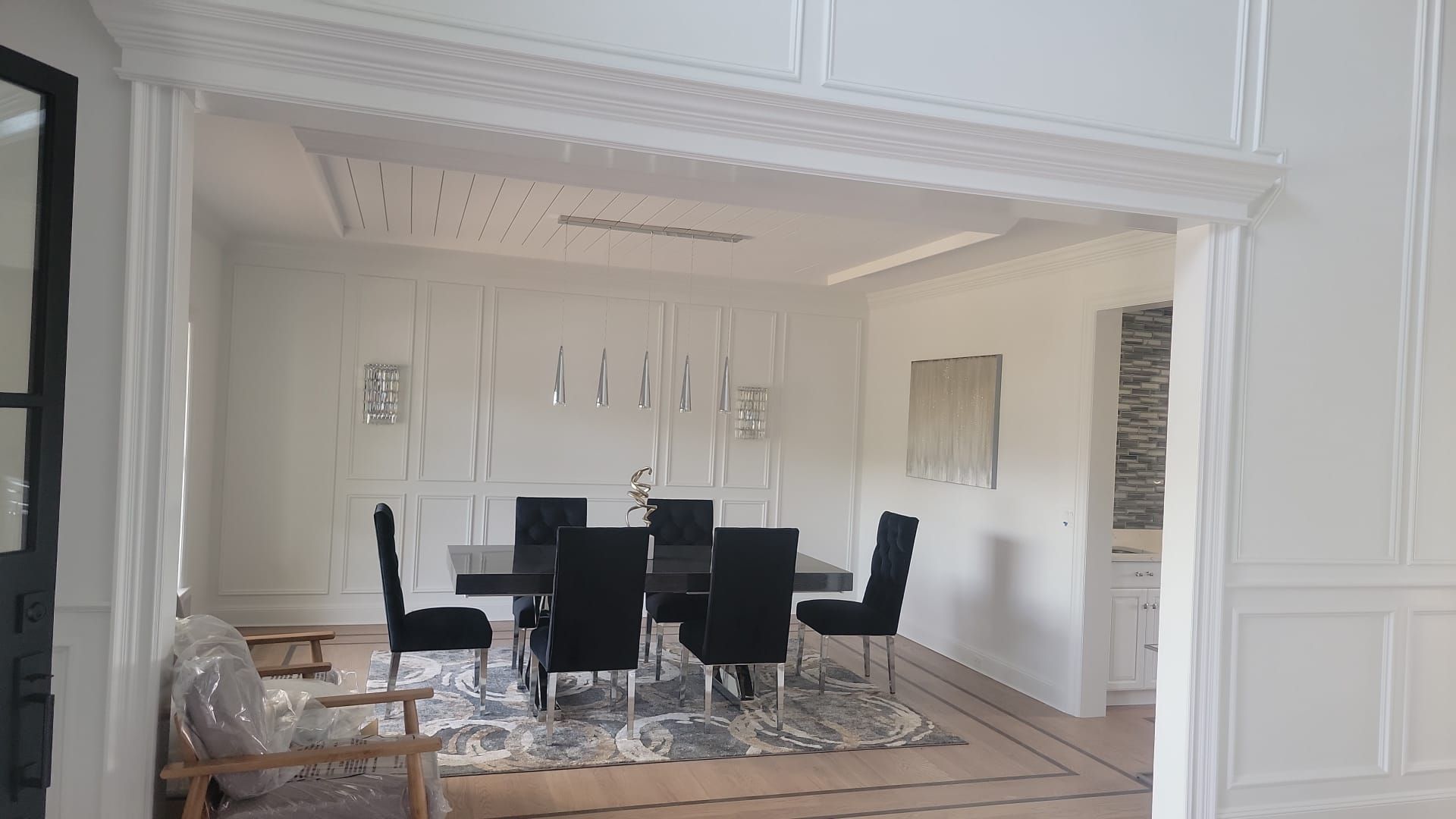 A dining room with a table and chairs in a house.