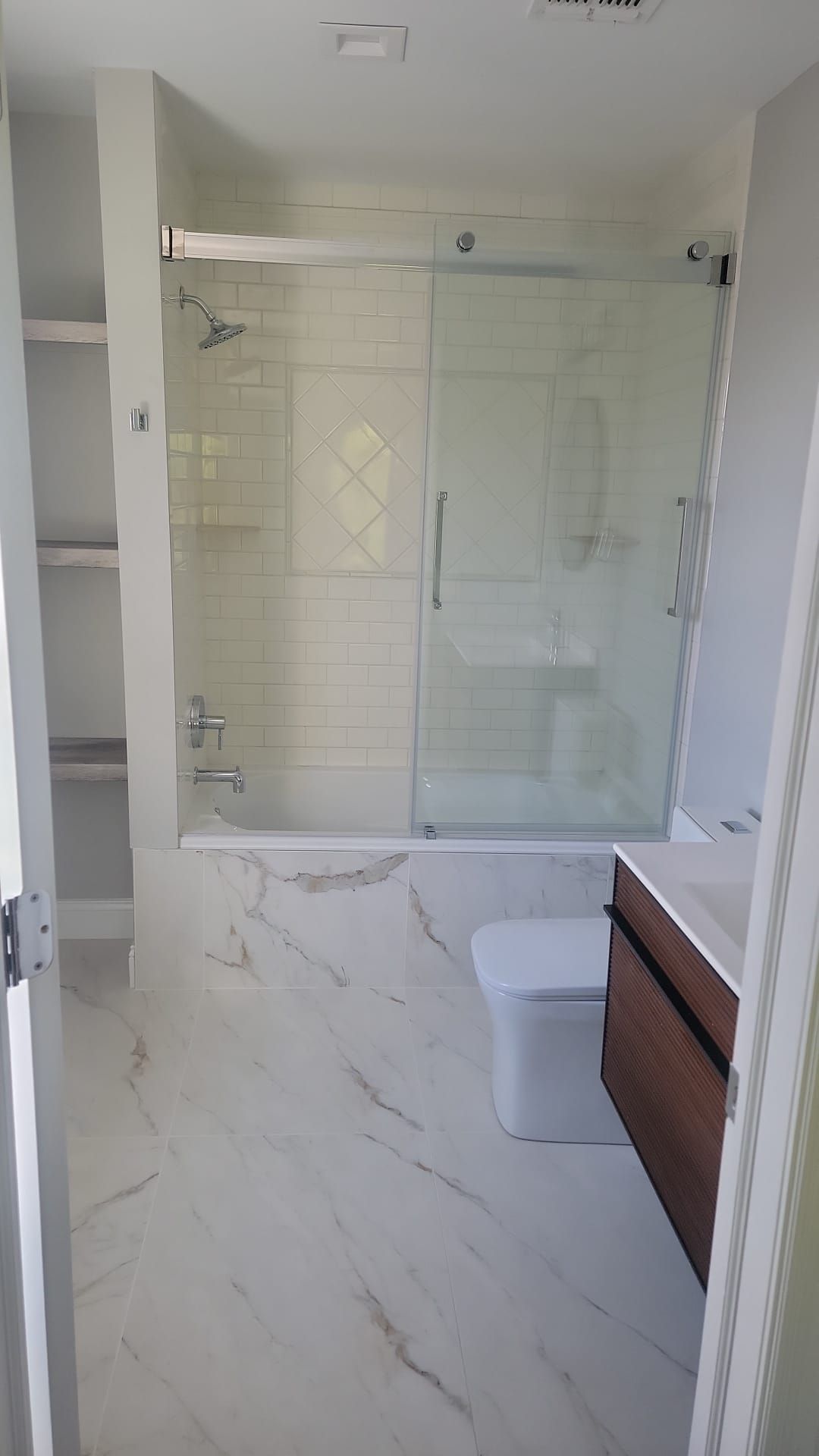 A bathroom with a toilet, sink, shower and bathtub.