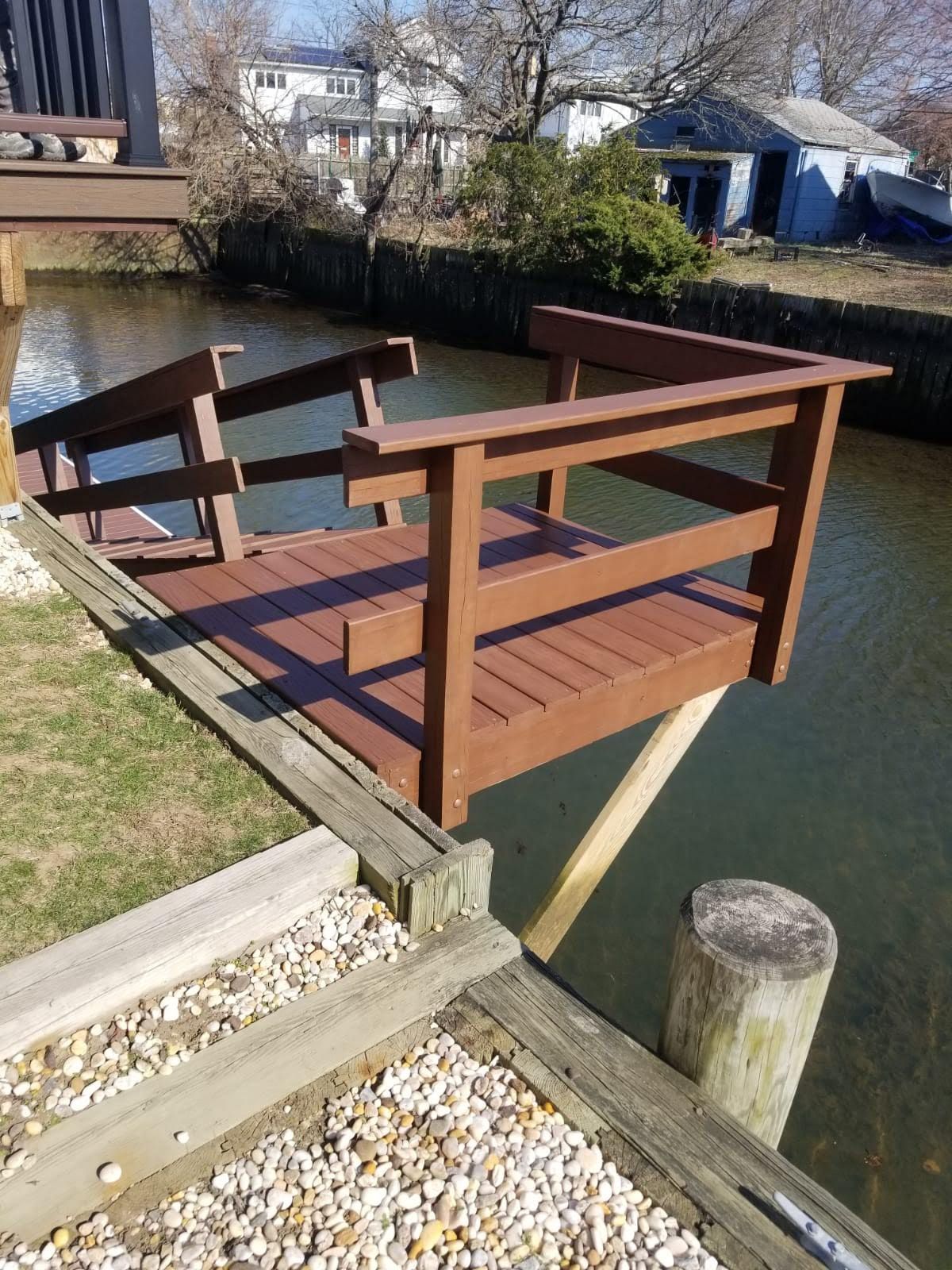 A wooden dock with stairs leading to a body of water.