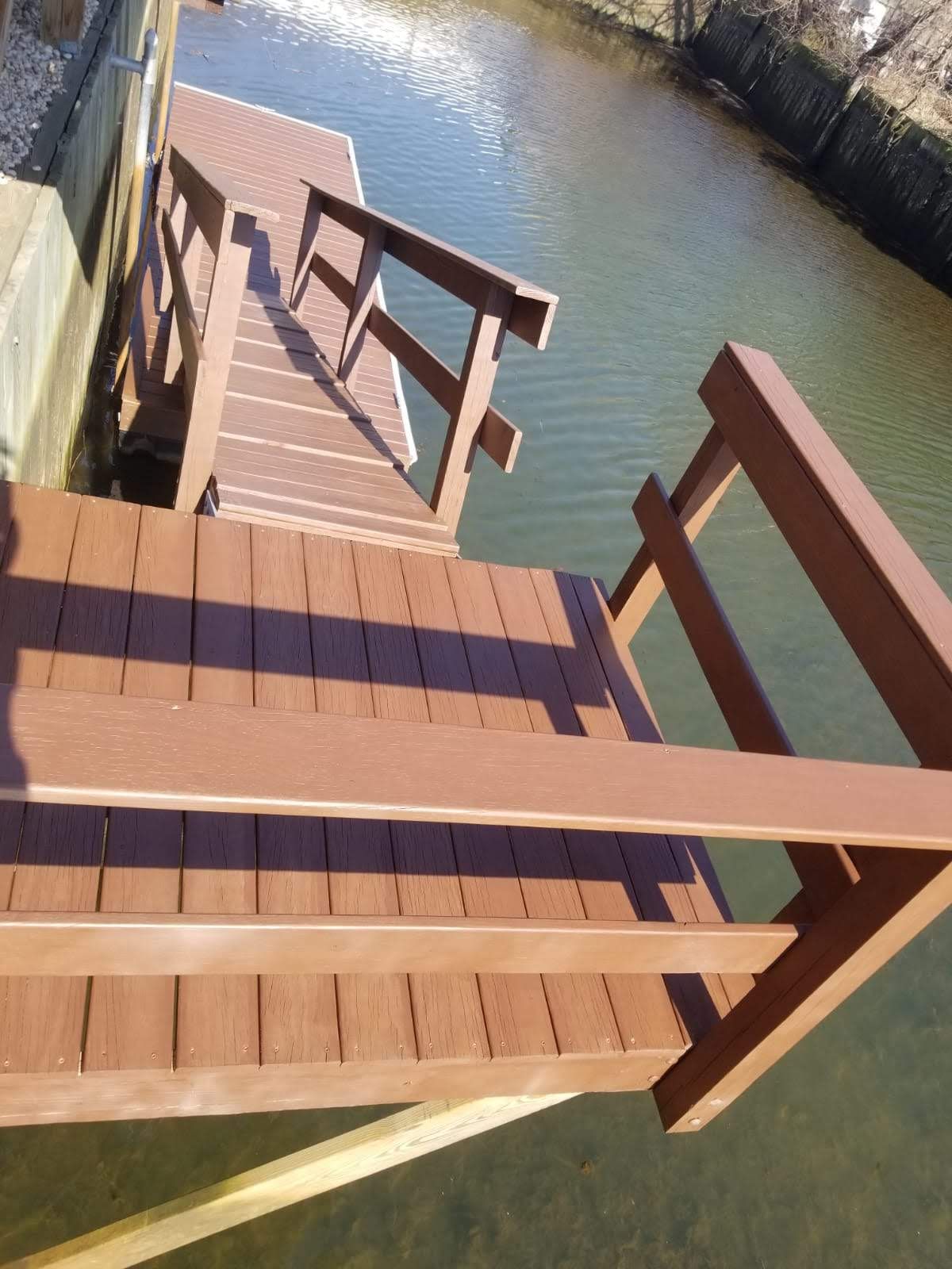 A wooden dock with stairs leading to the water