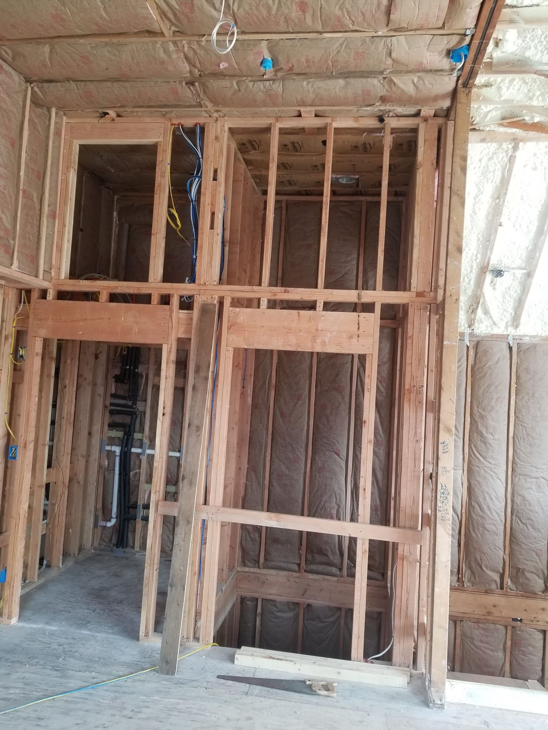 A room with a lot of wooden walls and a hole in the floor.