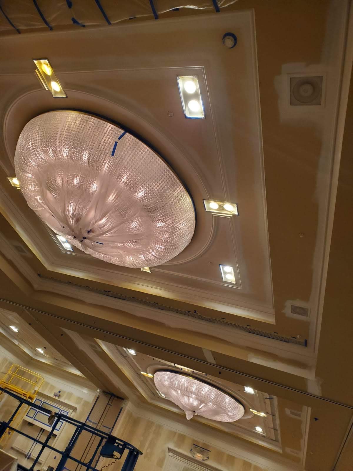 A large chandelier is hanging from the ceiling of a room