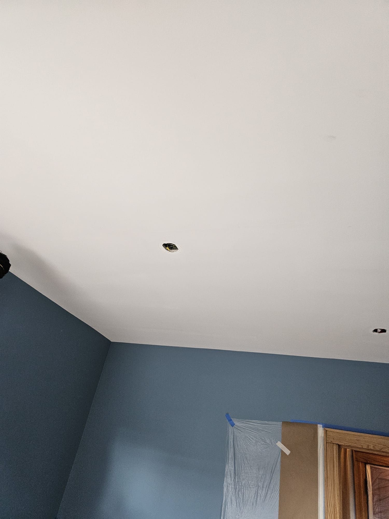 A room with blue walls and a white ceiling.