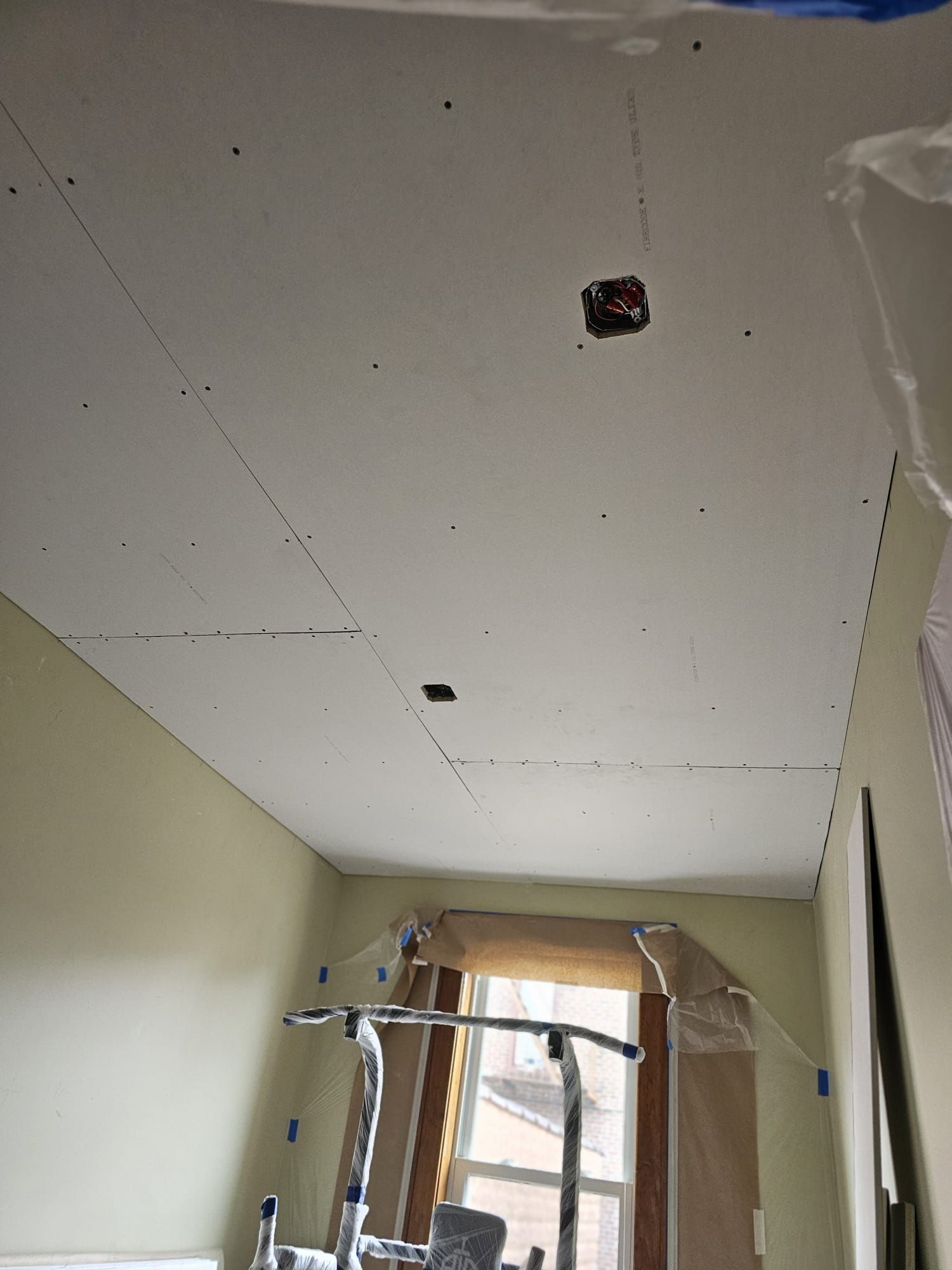 A room with a ceiling that has a hole in it