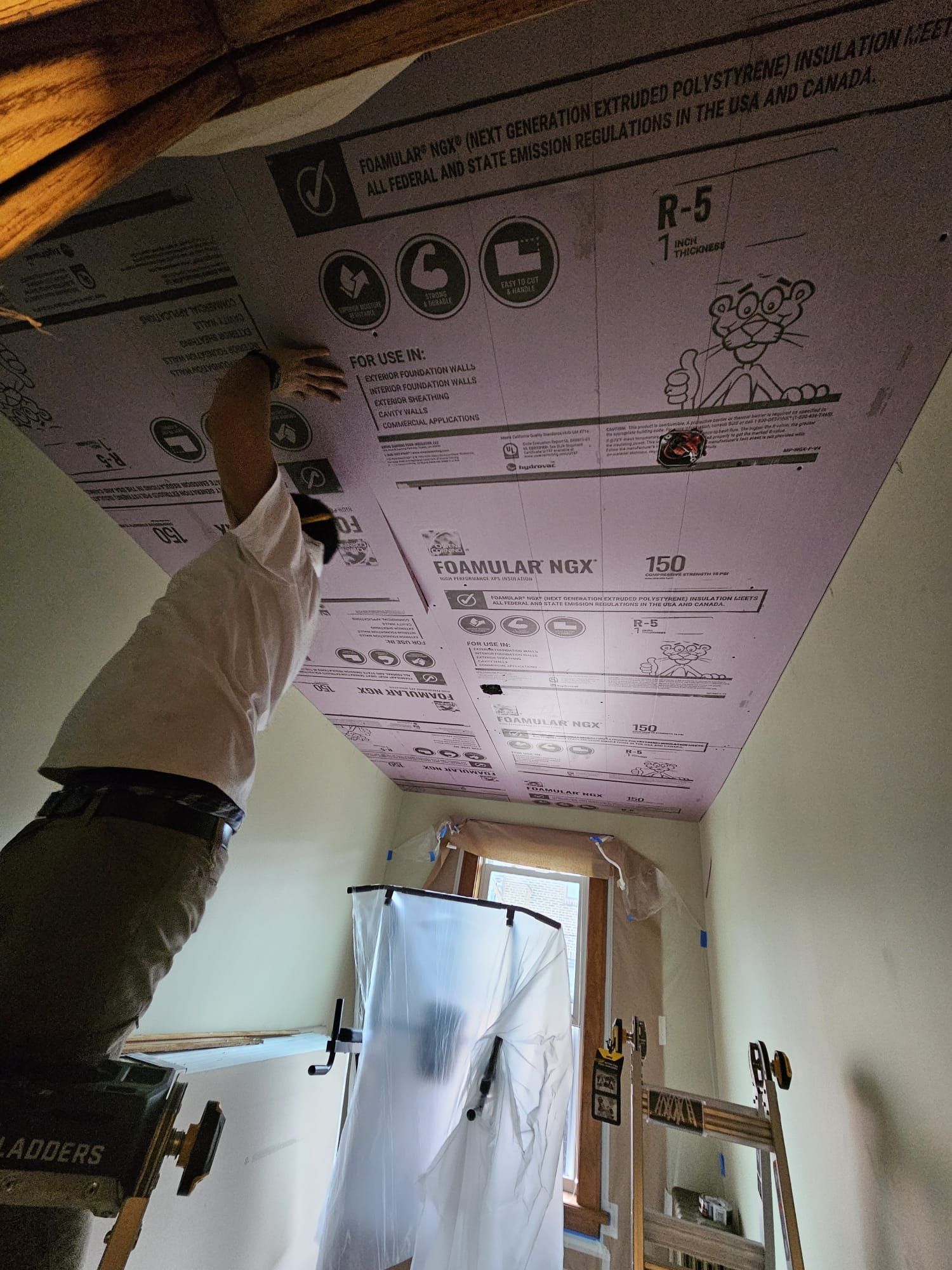 A man is working on a ceiling with a box on it.