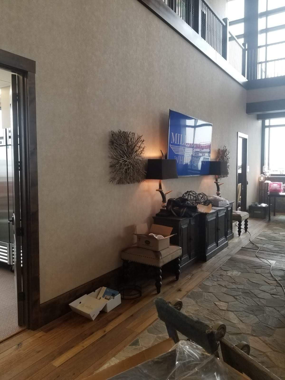 A living room with a large flat screen tv on the wall