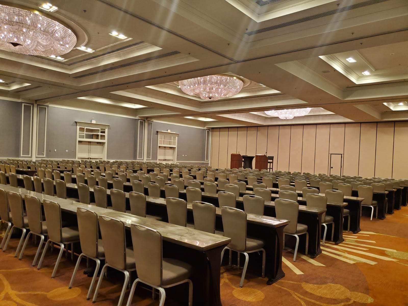 A large conference room filled with tables and chairs.