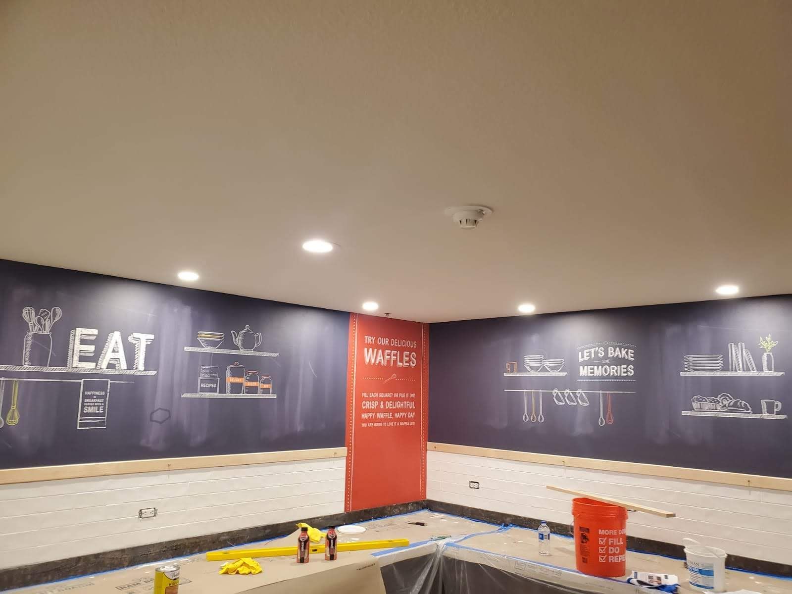 A kitchen with a chalkboard on the wall