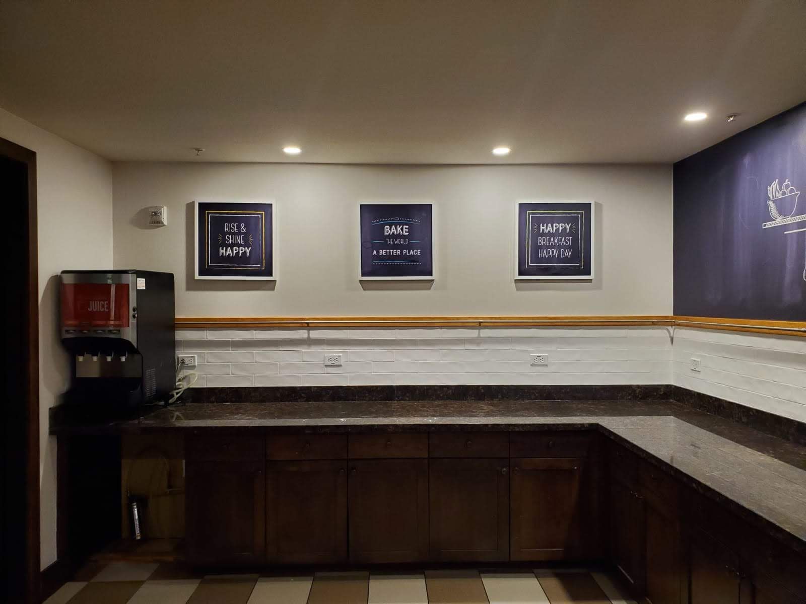 A kitchen with a coffee maker and a chalkboard on the wall.