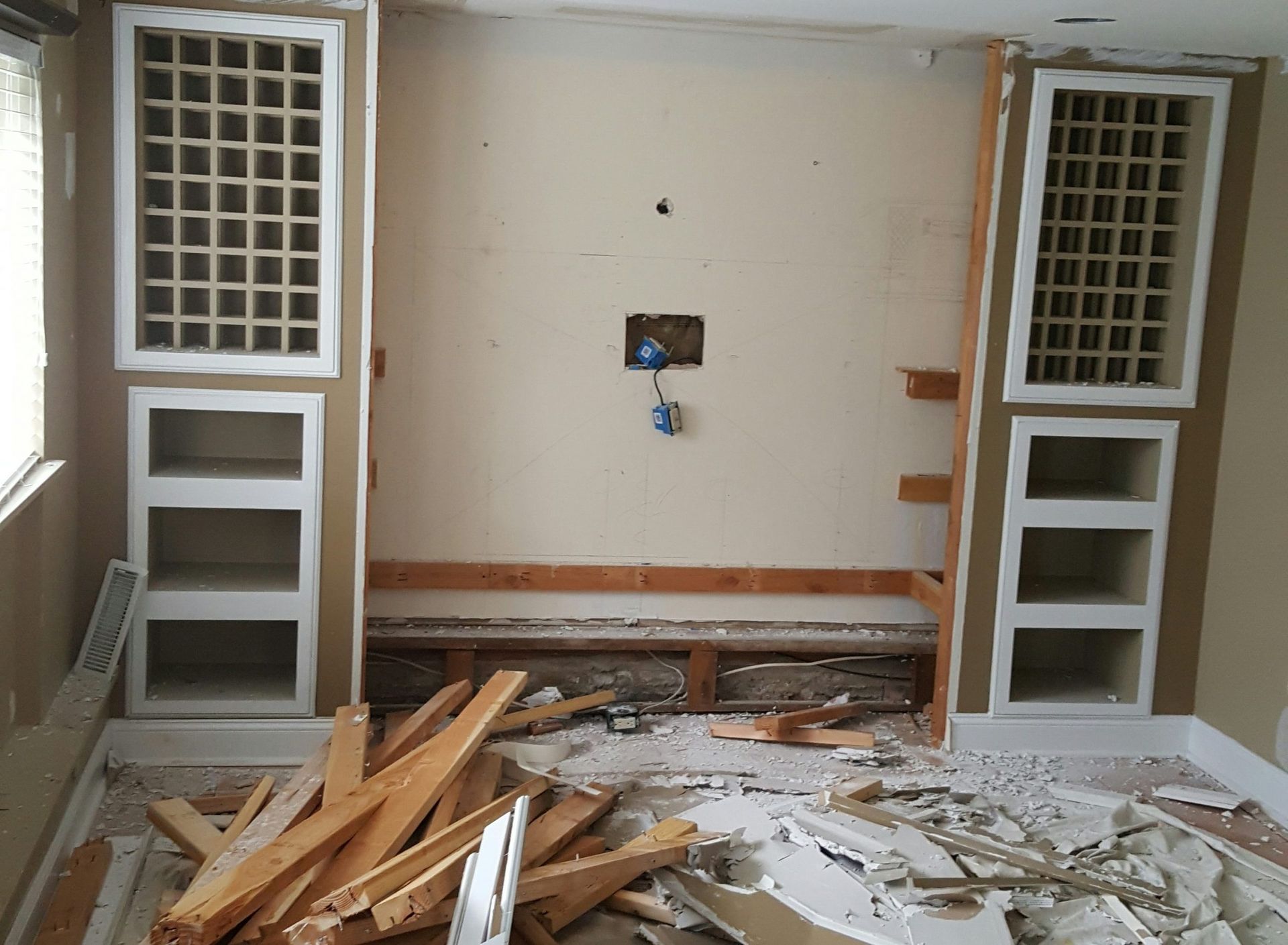 A room that is being remodeled with a lot of wood on the floor