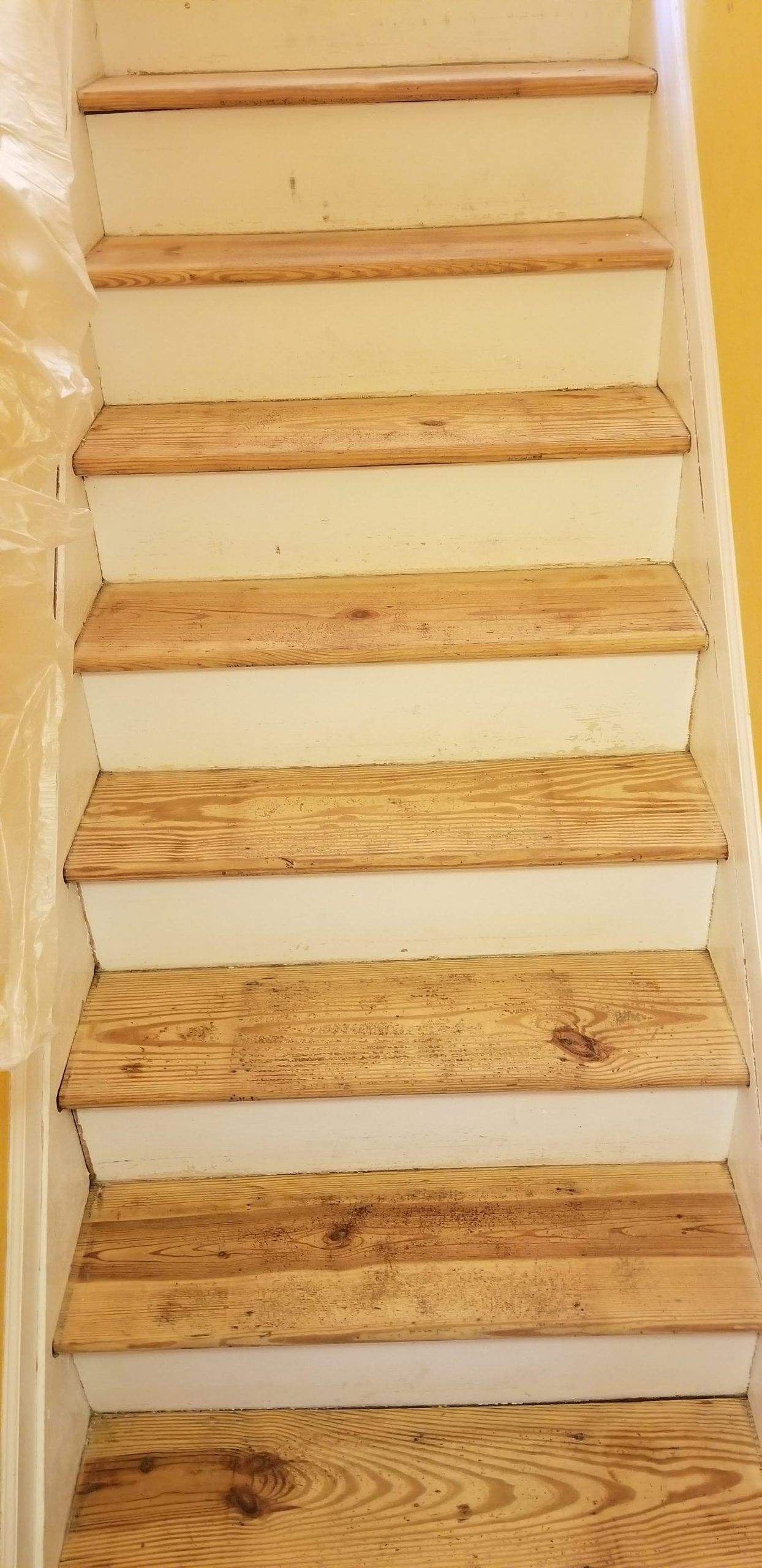 A set of stairs with wooden steps and white risers.