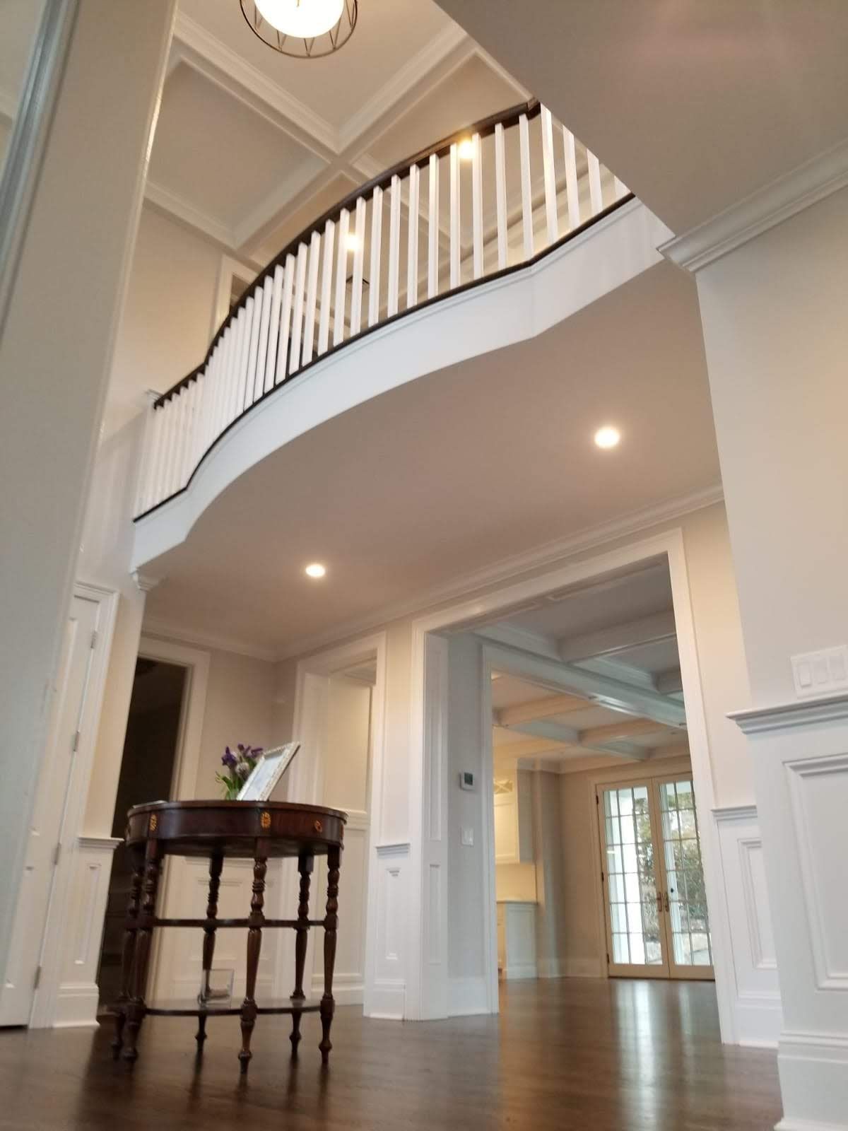 Looking up at a staircase with a table in front of it