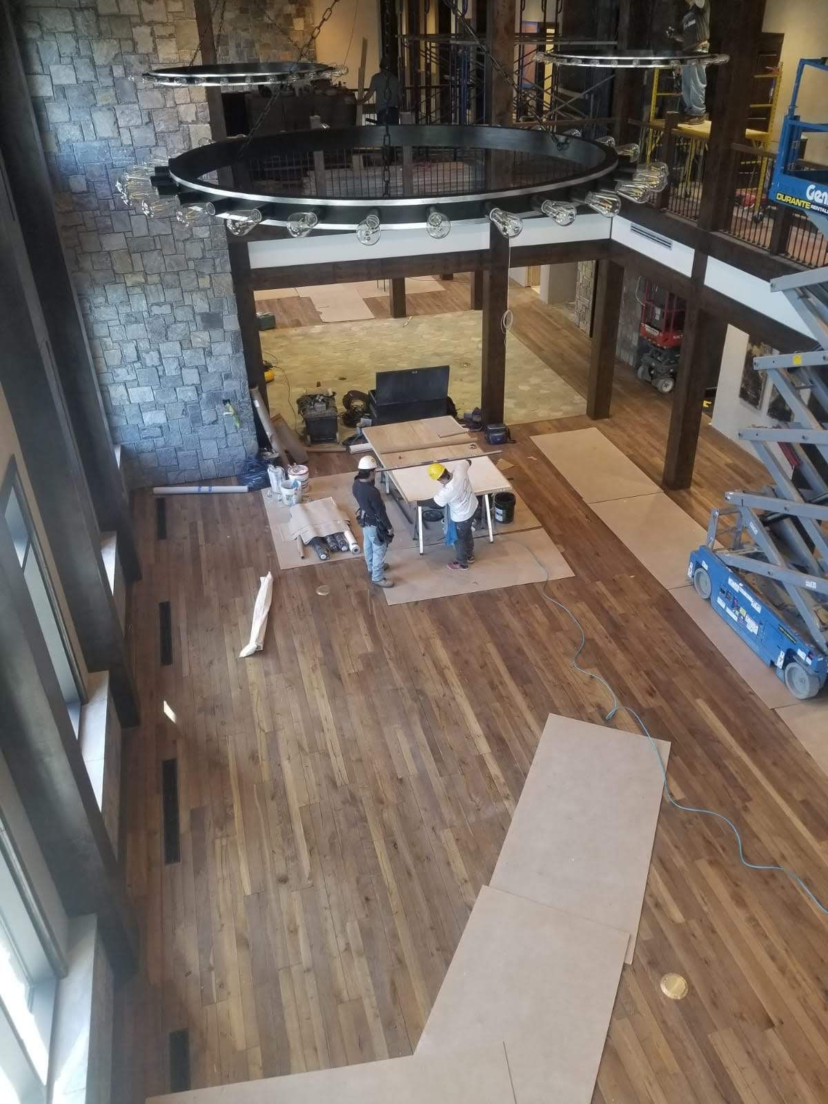 An aerial view of a large room with a wooden floor.