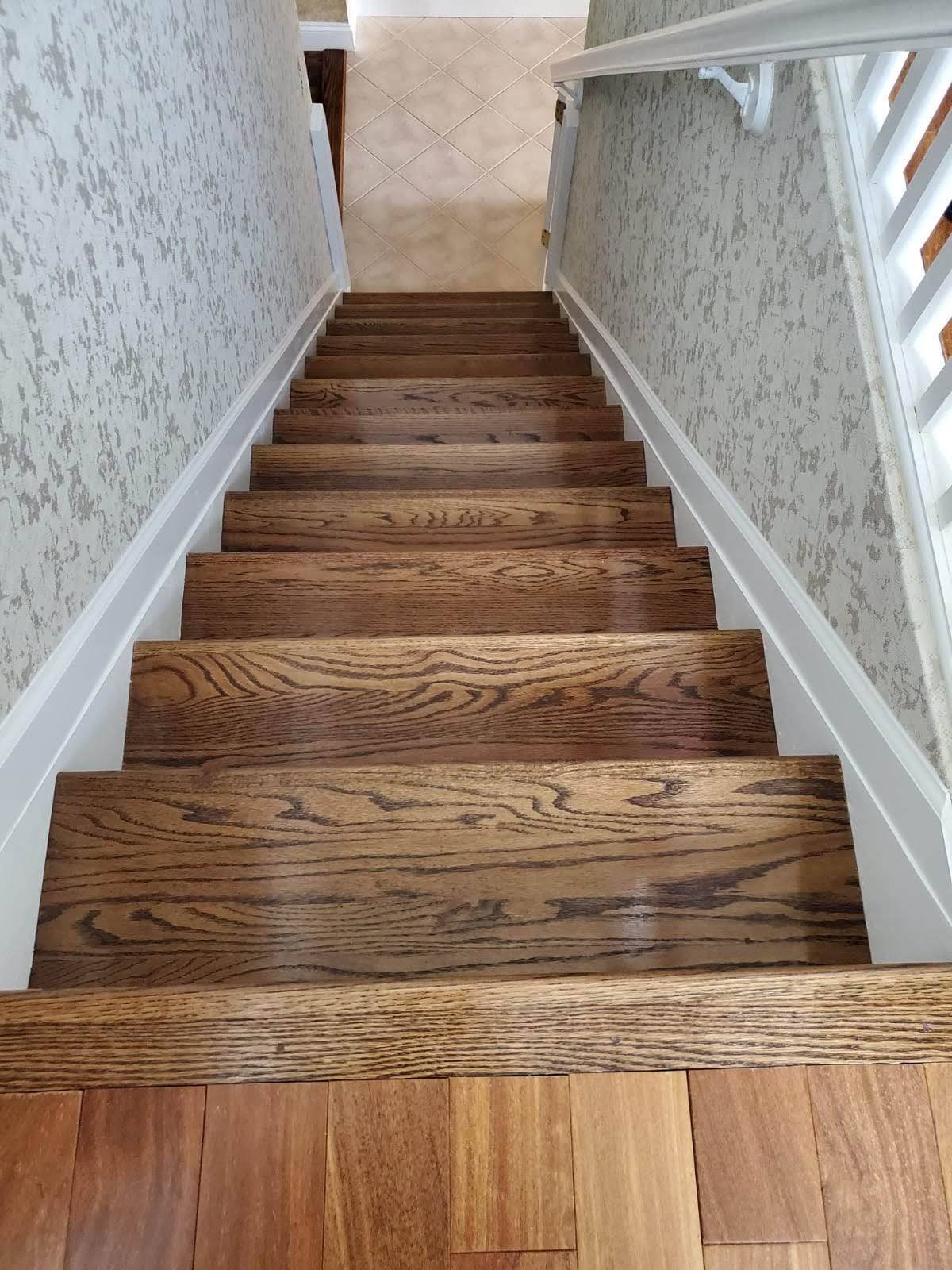 The stairs are made of wood and have a white railing.