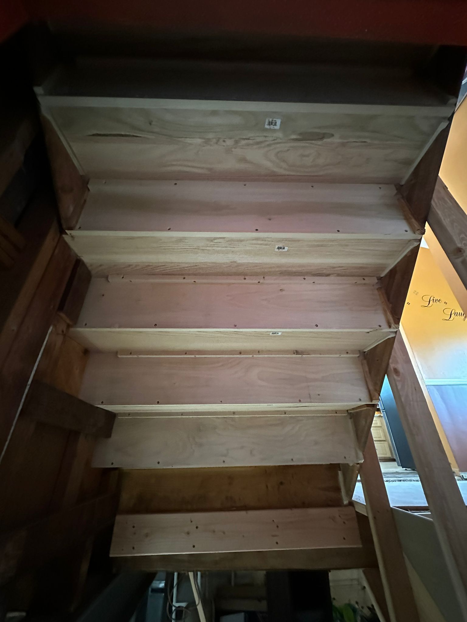 A wooden staircase is being built in a house.