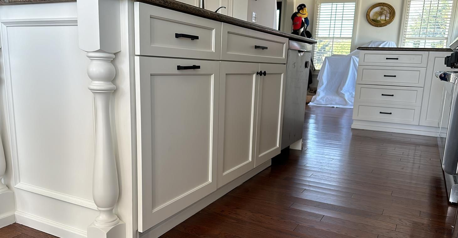 A kitchen with white cabinets and stainless steel appliances.