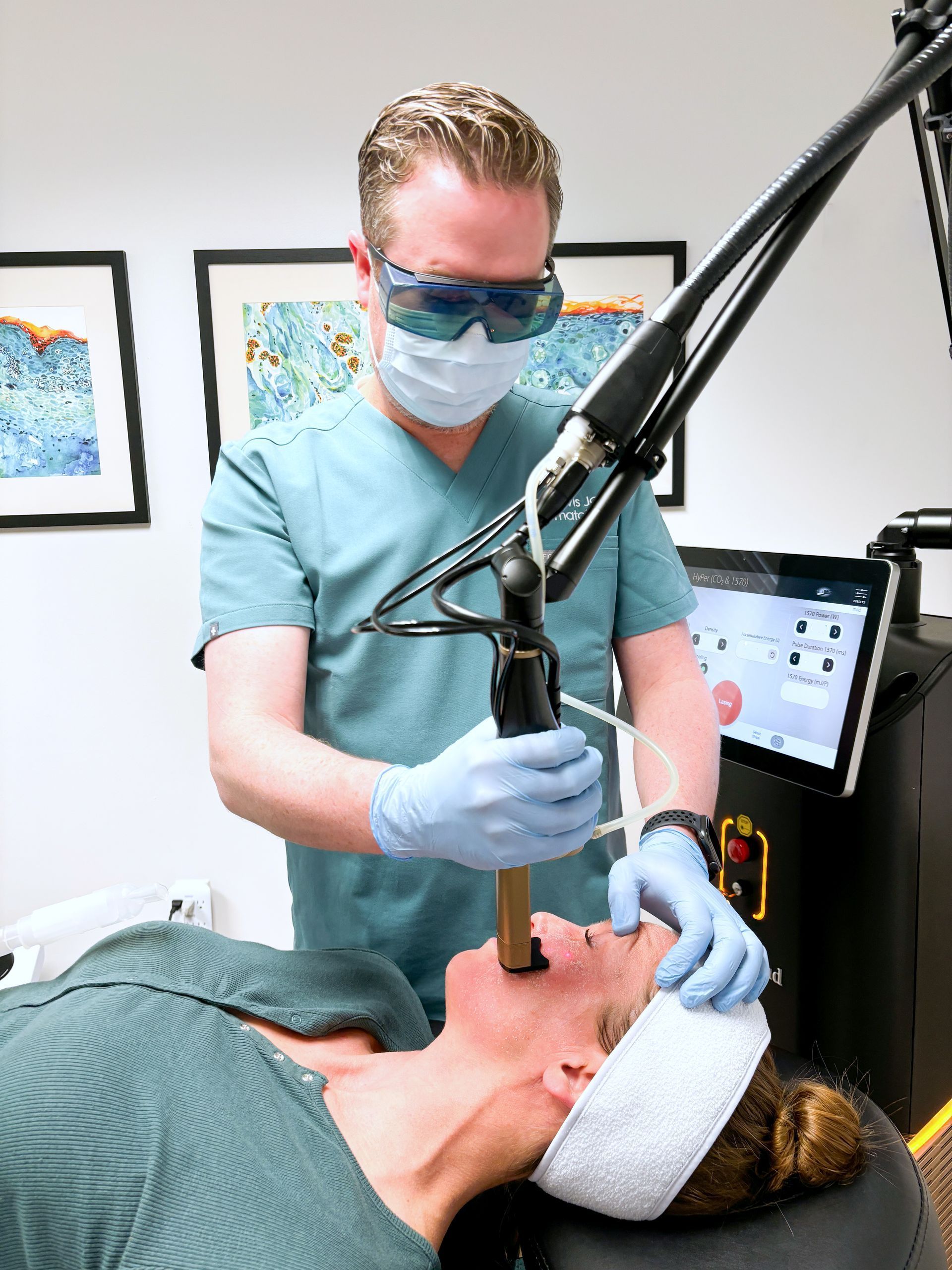 Dentist using a laser on a patient's mouth during a dental procedure