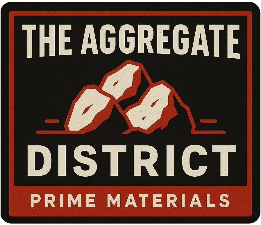 Logo for "The Aggregate District: Prime Materials" featuring a tan-colored rock formation on a dark background.