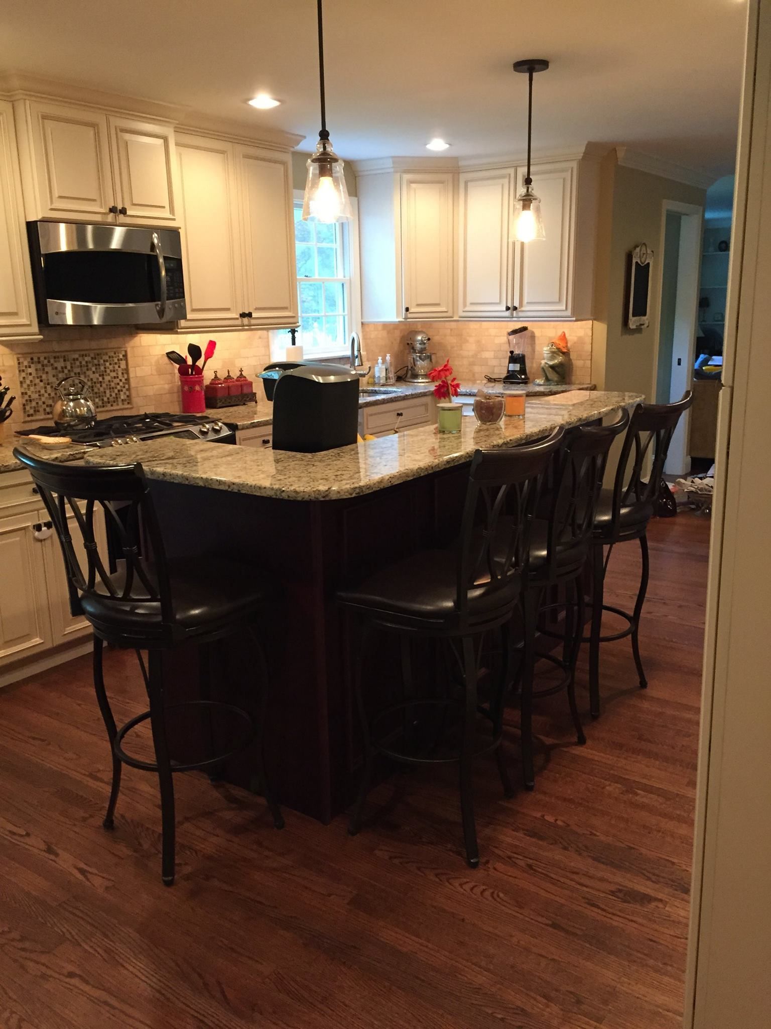 A kitchen with a large island and stools