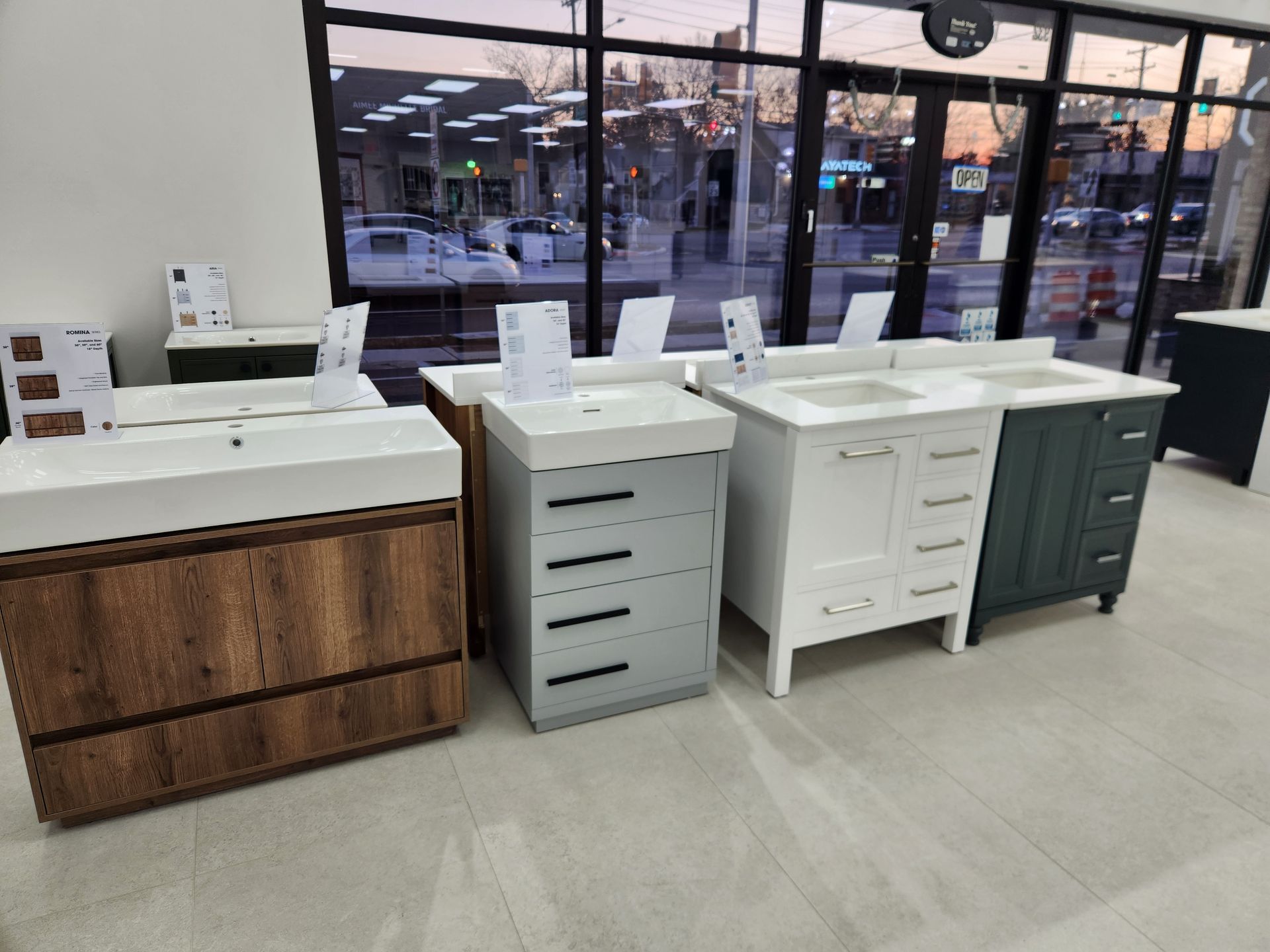 Bathroom vanities displayed in a store with varying colors and styles