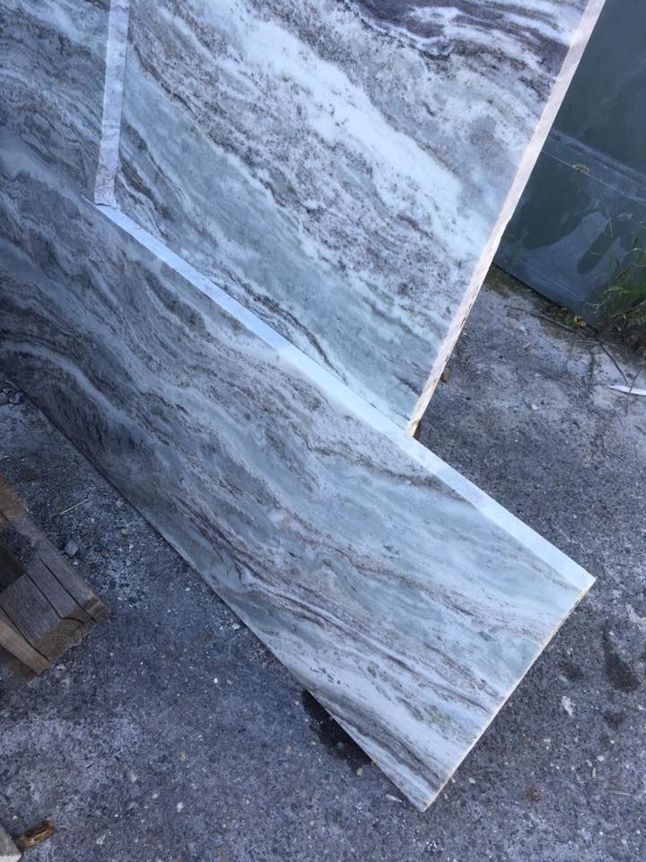Two pieces of marble are laying on the ground.