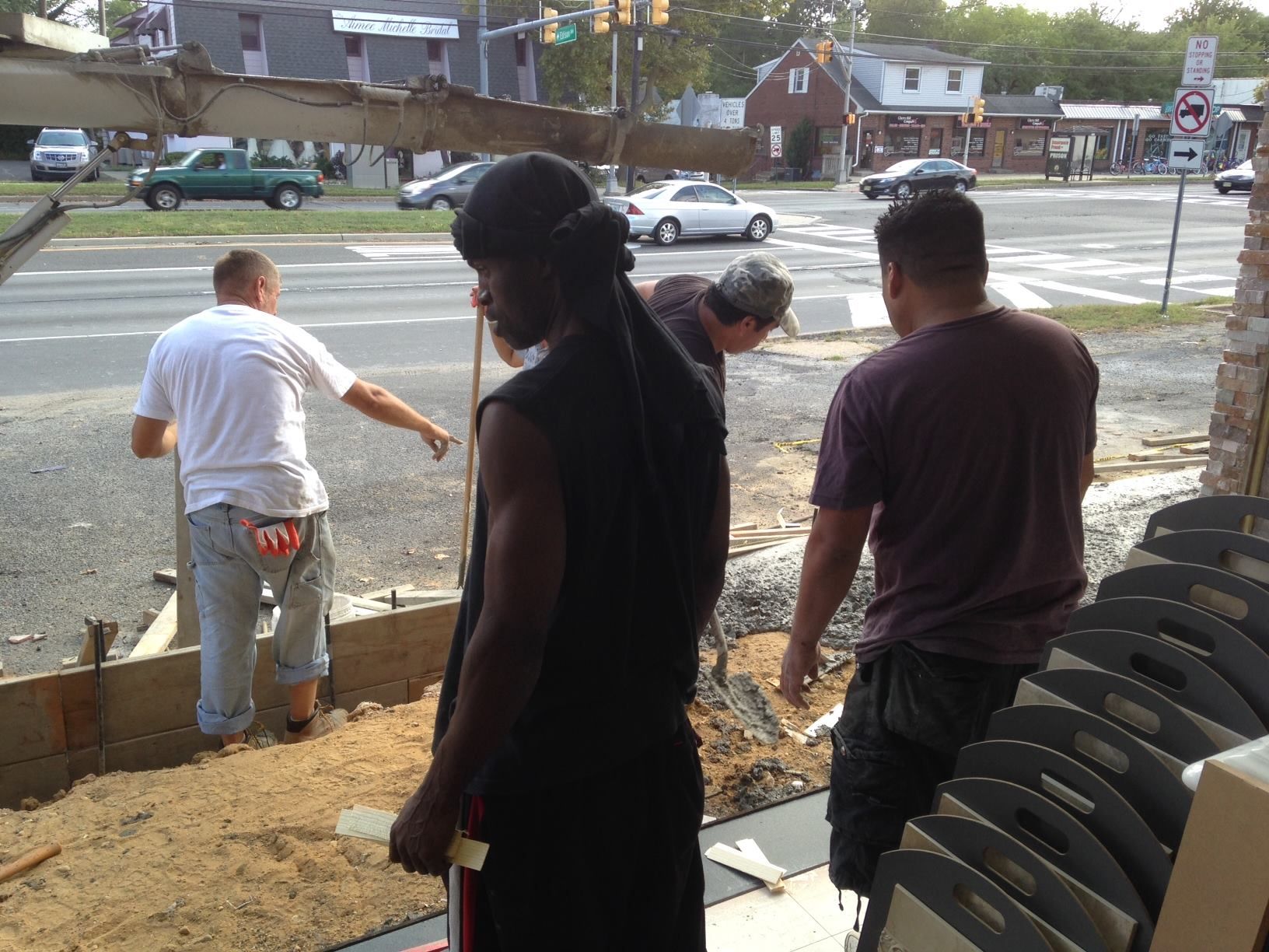 A group of men standing in front of a stop sign