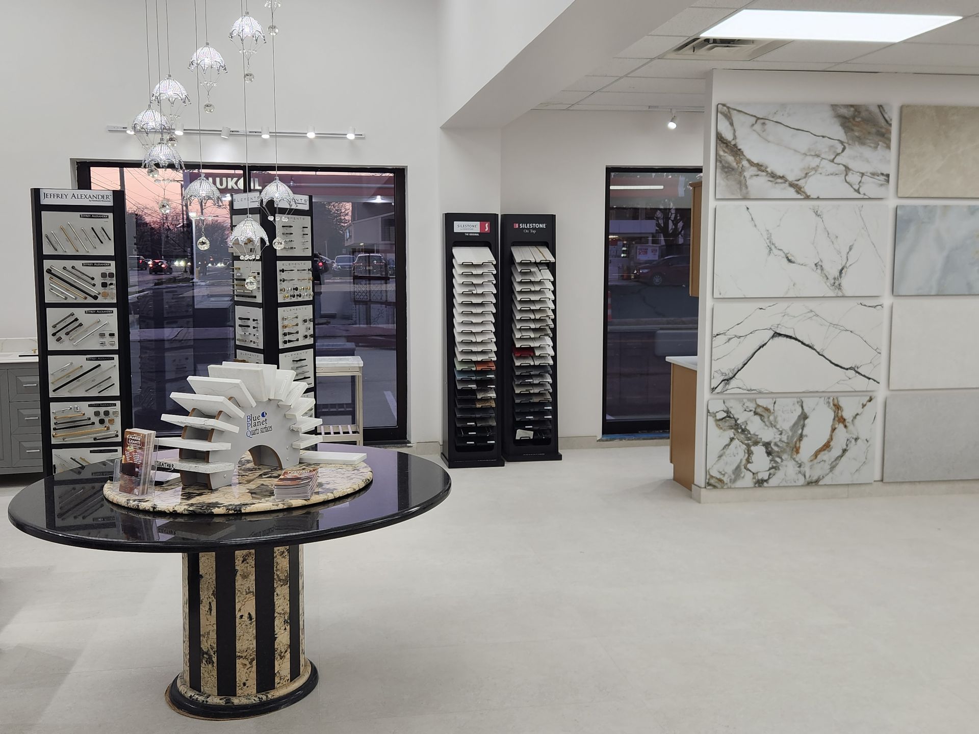 Interior showroom with tile and stone samples displayed on walls and tables