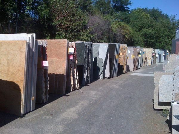 A row of marble slabs are lined up on the side of a road