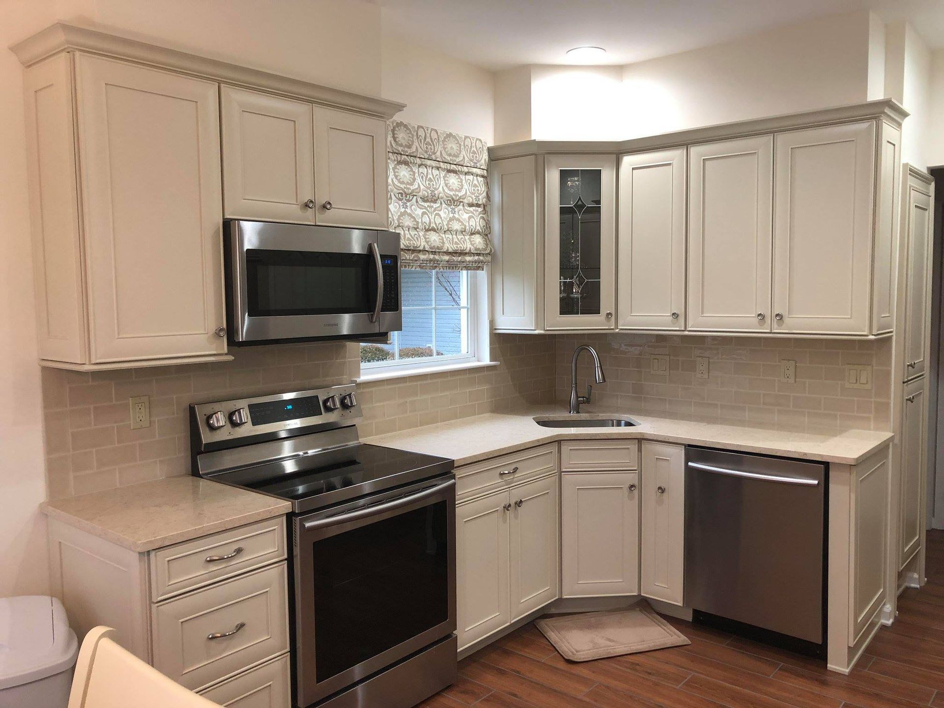 A kitchen with white cabinets and stainless steel appliances